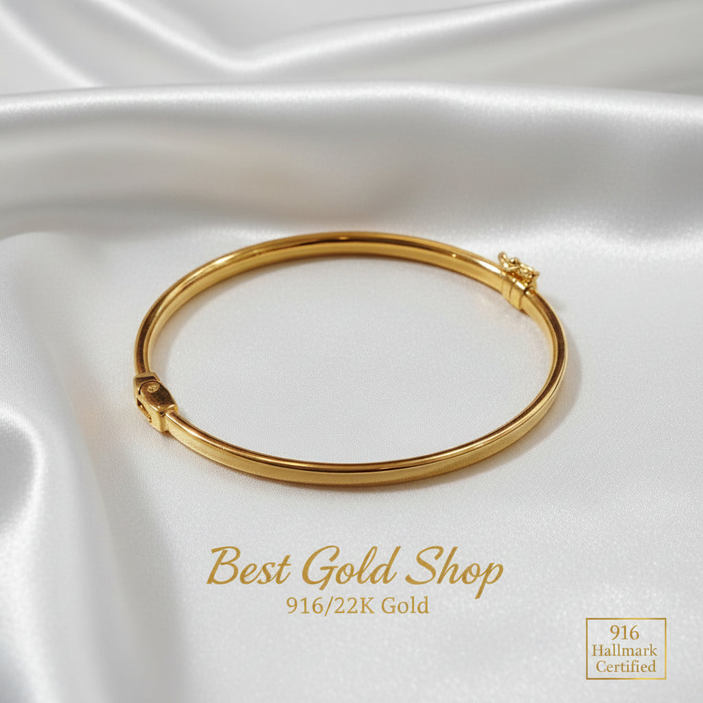 Detailed view of a polished 916 gold hollow shiny bangle
