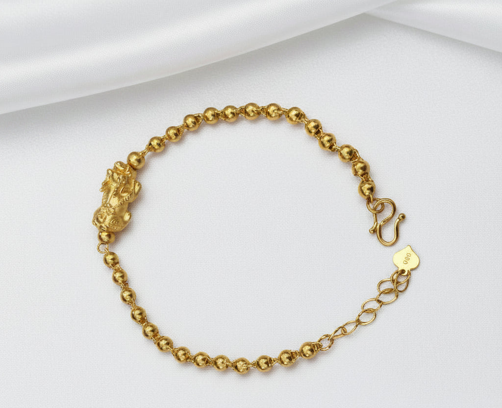 Full view of the 999 gold Pixiu bead bracelet with S-hook clasp, extension chain and heart-shaped tag