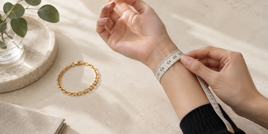 Measuring a wrist with a soft tape beside a generic gold bracelet