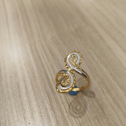 Angled view of a 916 gold two-tone swirl ring showing silver-coloured spiral accents and the gold band
