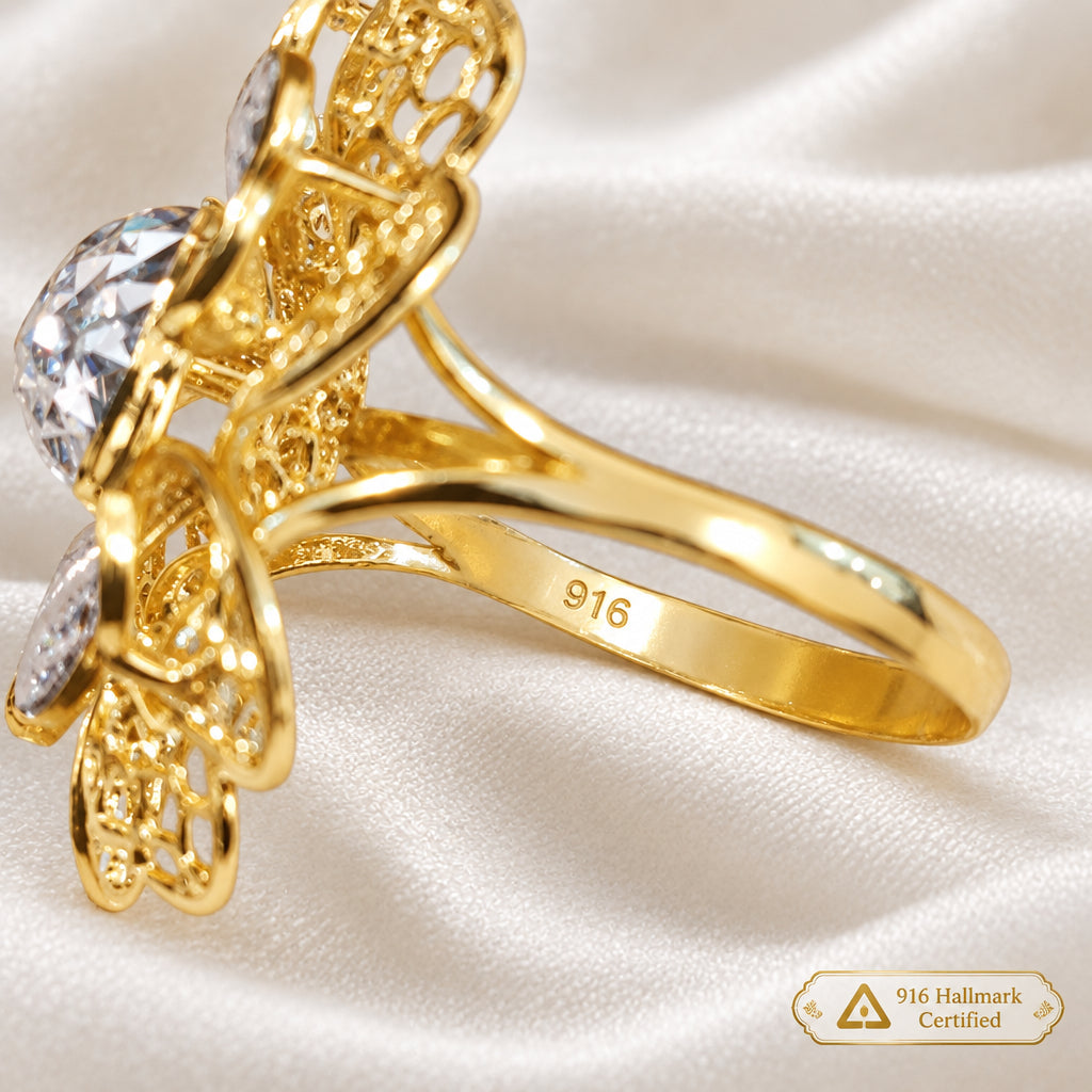 Side view of a 916 gold floral ring showing the openwork setting and 916 stamp inside the band