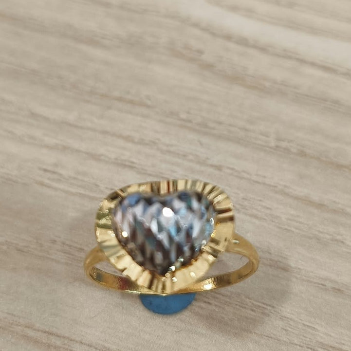 Front view of a 916 gold two-tone heart ring with a textured silver-coloured heart and gold border on pale wood