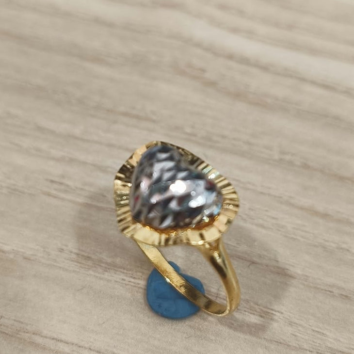Angled view of a 916 gold two-tone heart ring showing its textured heart detail and slim gold band