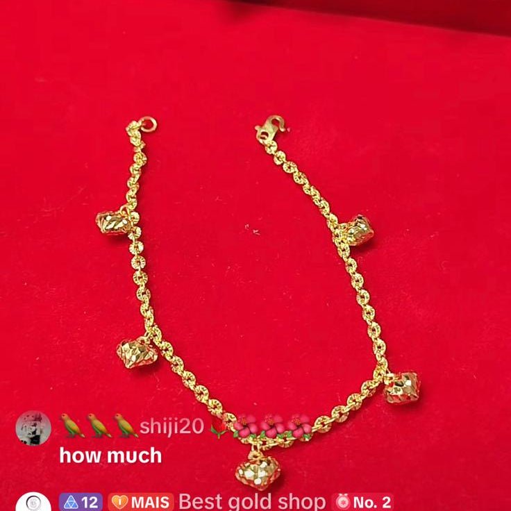 916 gold sunflower bracelet with five dangling heart charms on a red background