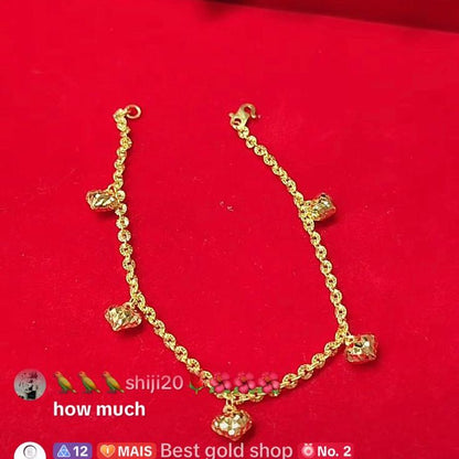 916 gold sunflower bracelet with five dangling heart charms on a red background