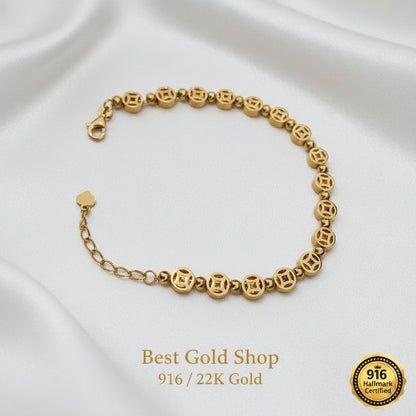 Close-up of Chinese coin charms on a 22K Gold bracelet.