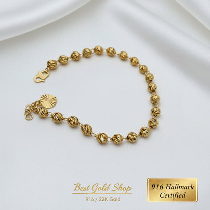 Close-up of diamond-cut balls on a 22K Gold bracelet.