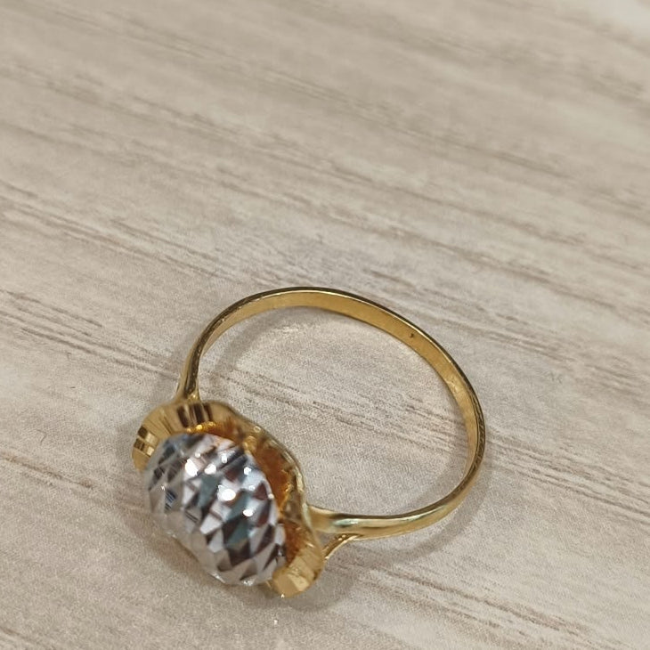 916 gold two-tone heart ring viewed from above showing the circular band and raised textured heart detail