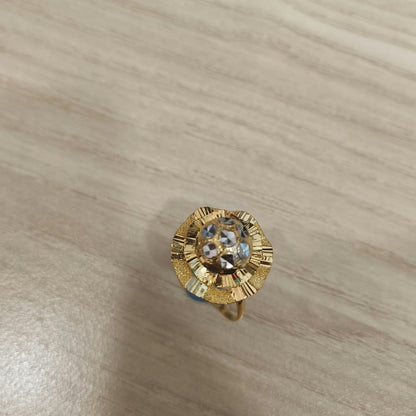 Top view of a 916 gold two-tone lotus ring showing textured gold petals and silver-coloured centre details