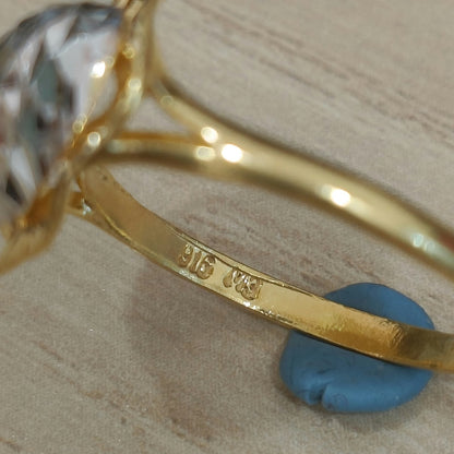 Close-up of the 916 stamp inside the gold band of a two-tone heart ring