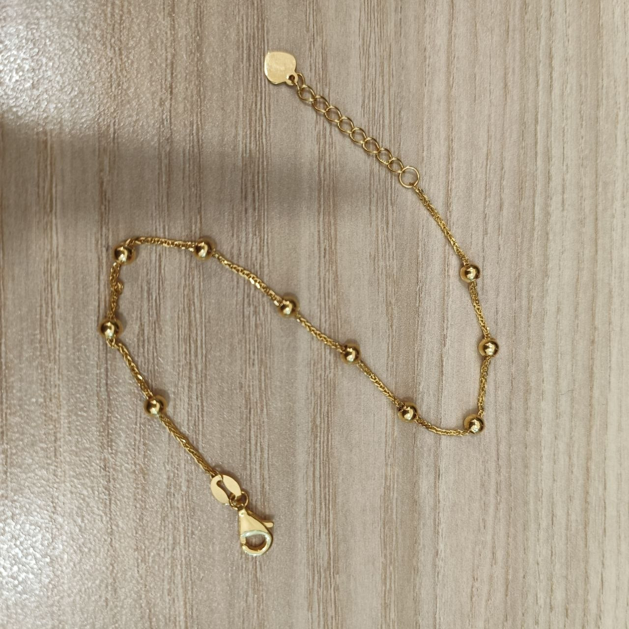 Adjustable 916 gold bead station bracelet with heart end tag