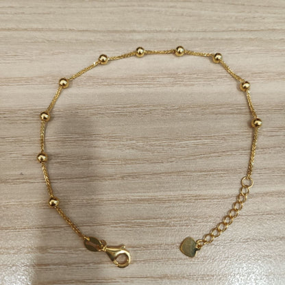 916 gold bead station bracelet laid flat with extender chain