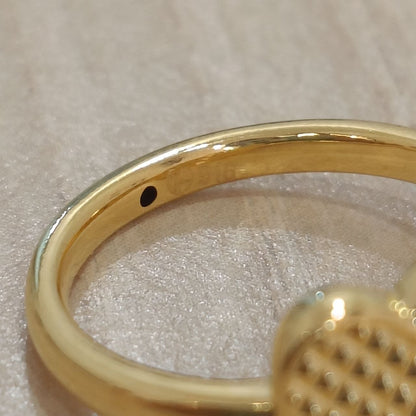 Close-up detail of 916 gold cross heart ring band