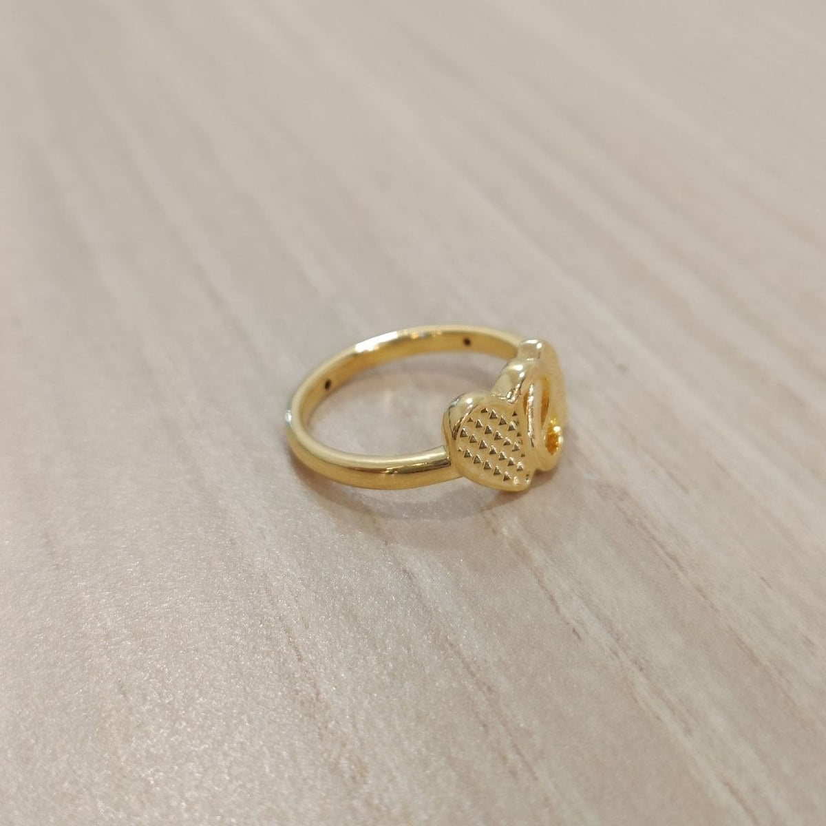 Side view of 916 gold cross heart ring