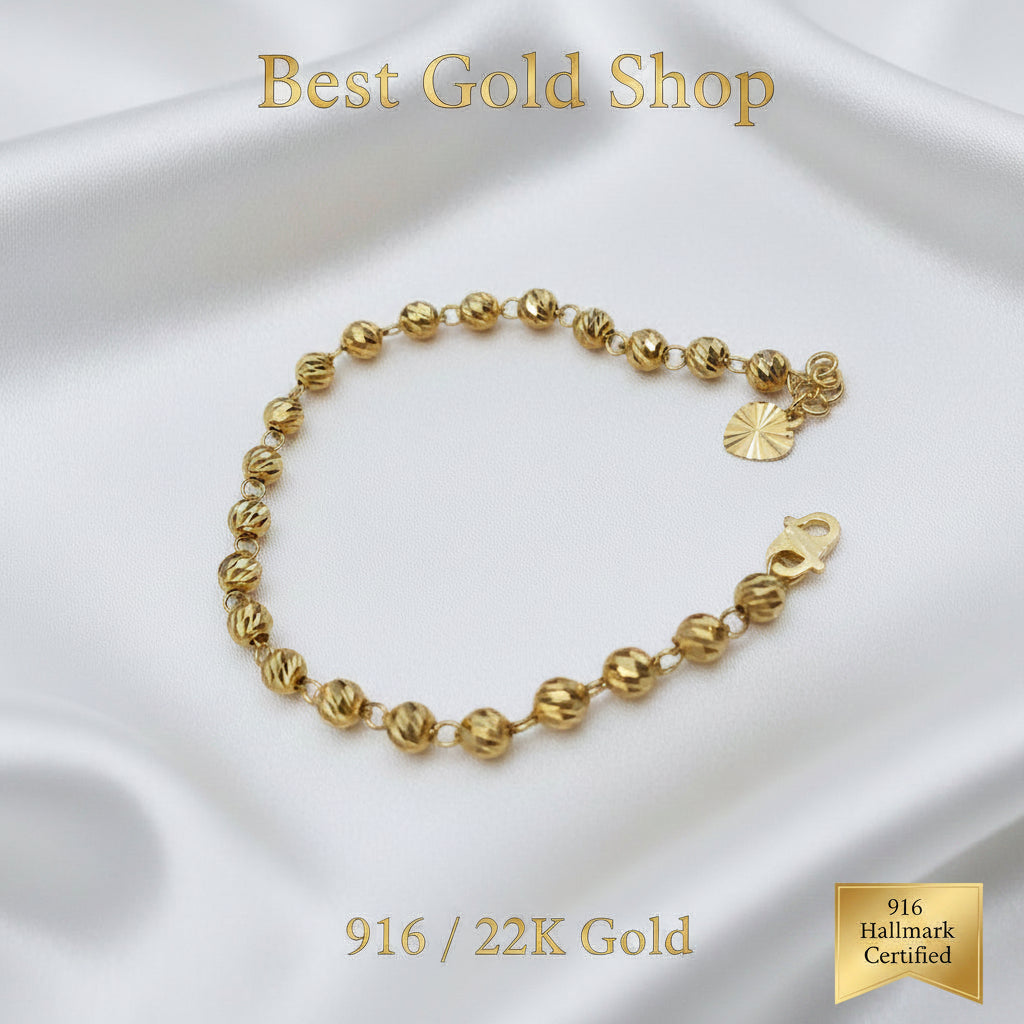 Detailed view of polished diamond-cut beads on a 916 Gold bracelet.
