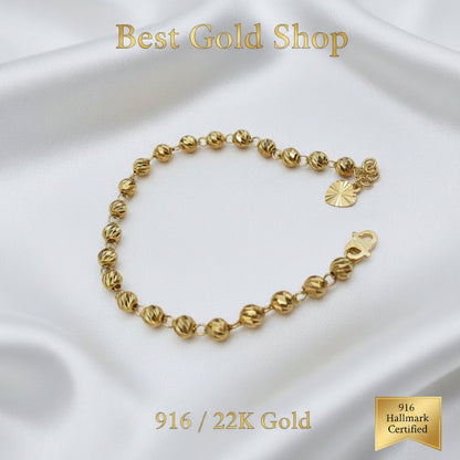 Detailed view of polished diamond-cut beads on a 916 Gold bracelet.