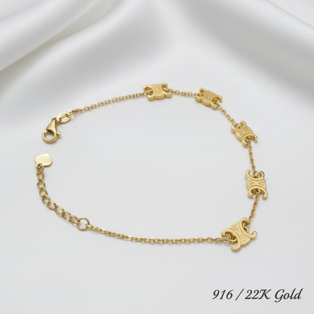 916 gold scroll link bracelet on white satin with five curled motifs, lobster clasp and extension chain