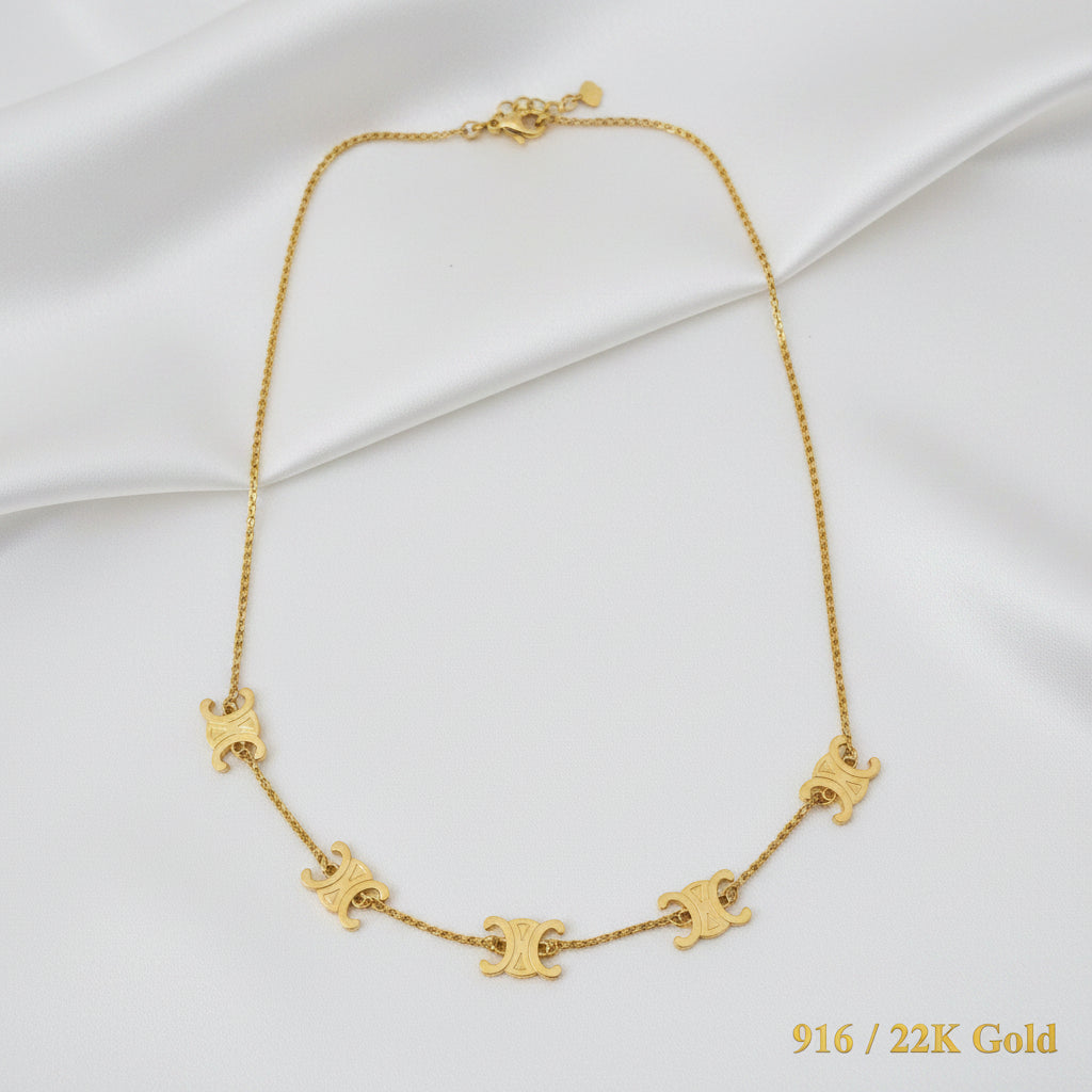 Close-up view of polished 916 gold fancy motif chain links