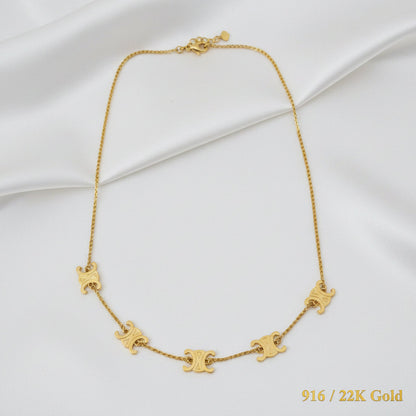 Close-up view of polished 916 gold fancy motif chain links