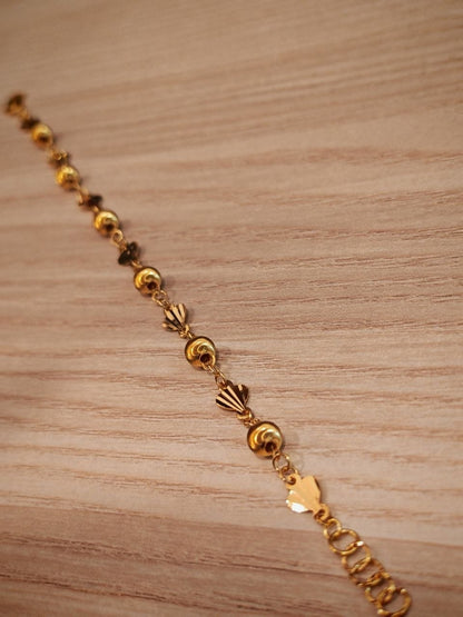 Fancy shell and polished ball stations on 916 gold bracelet