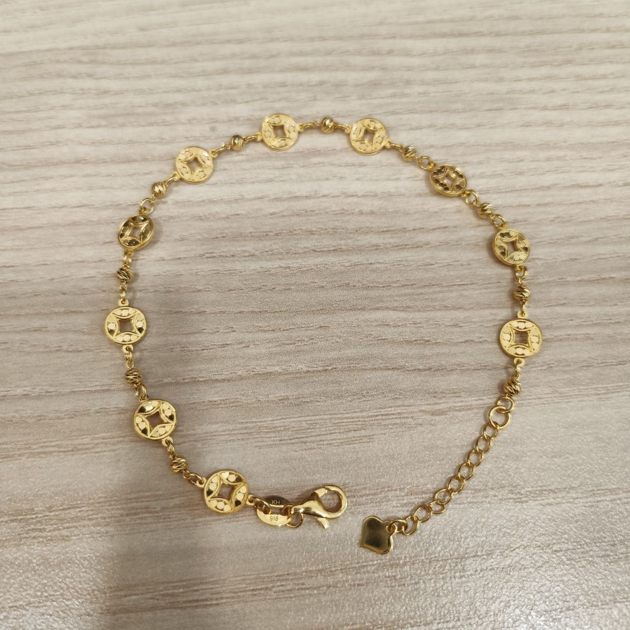 916 gold geometric round motif bracelet full front view