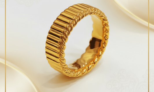 Complete gold grooved band ring standing at an angle, showing its ridged outer surface and opening