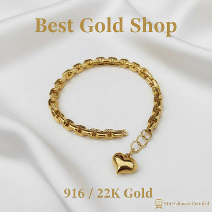 Polished 22K gold heart charm on the Wanzi link bracelet