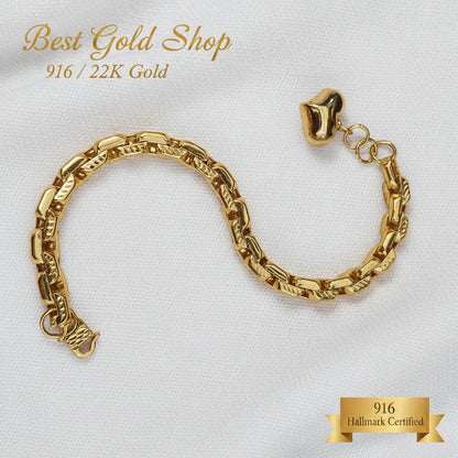 Detailed view of the textured gold links and dangling heart charm
