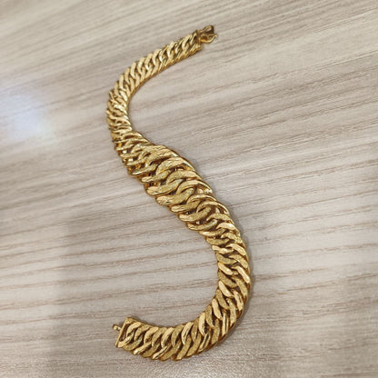 Side view of the wide hollow Lipan link bracelet in yellow gold