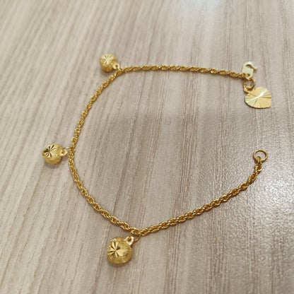 916 Gold hollow rope bracelet and heart charms angled view