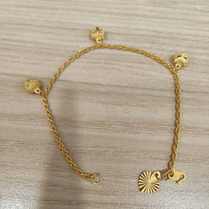 916 Gold hollow rope bracelet showing heart charms and clasp