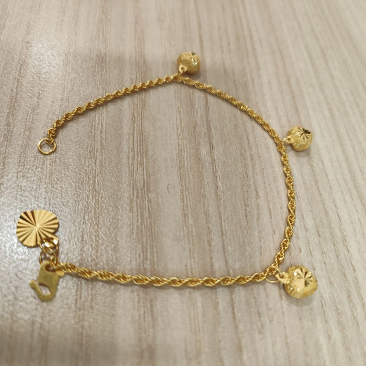 916 Gold hollow rope bracelet with three heart charms full view