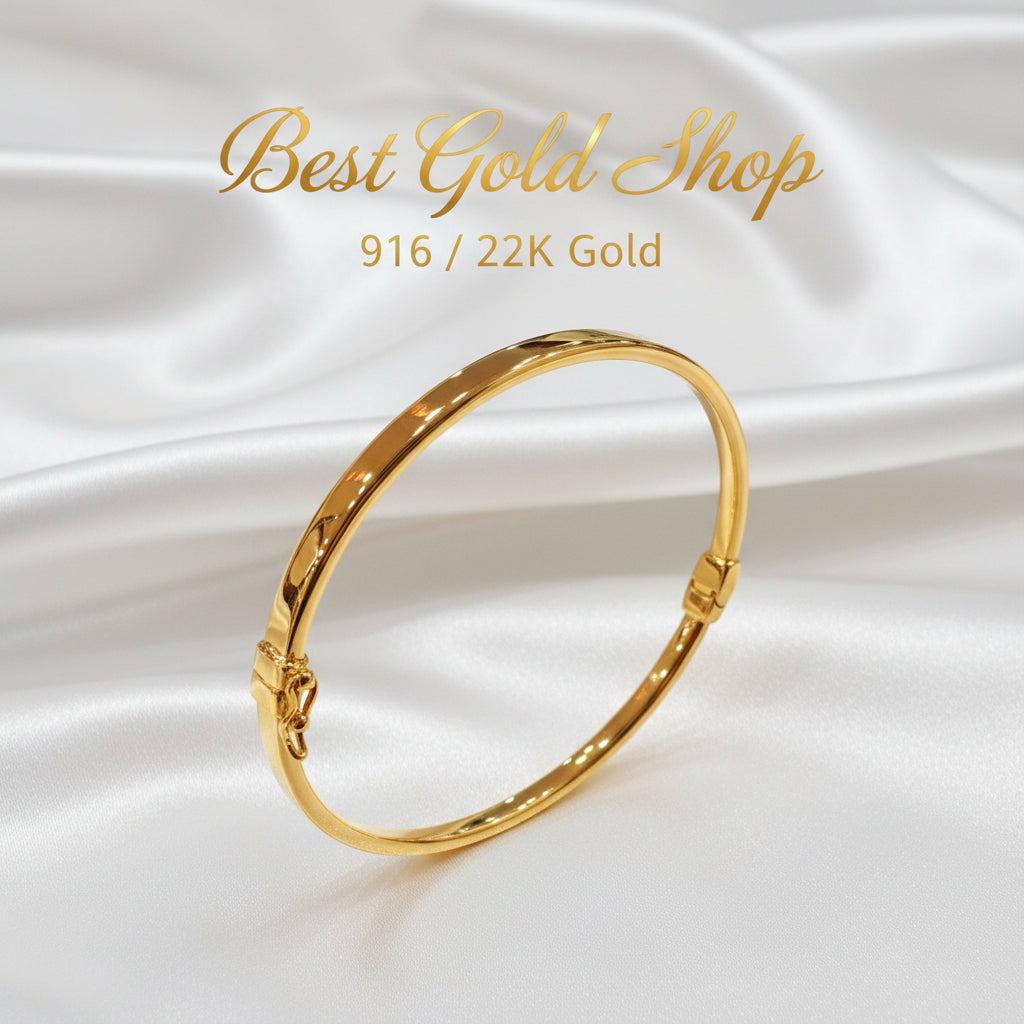 Angled view of a 916 gold hollow shiny bangle