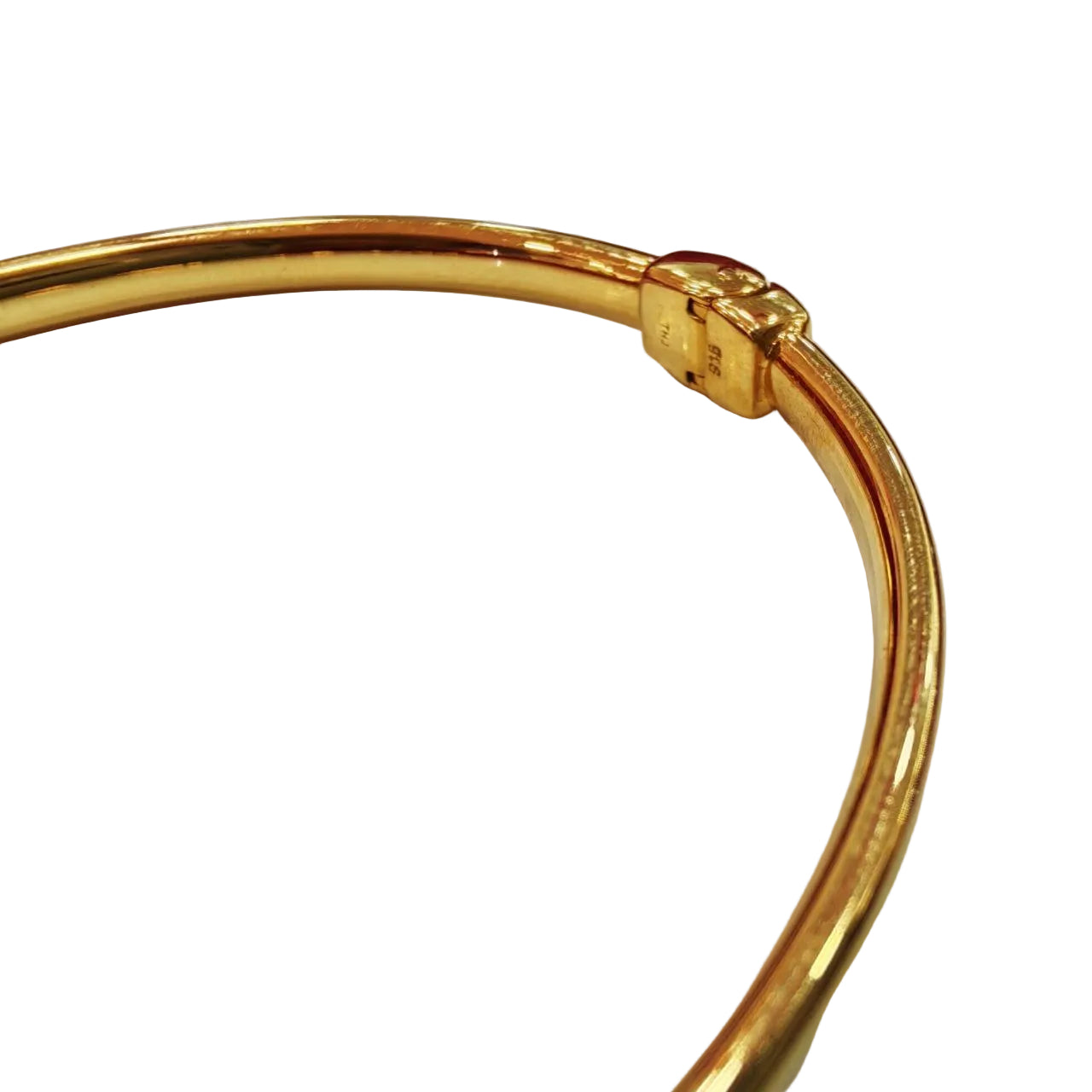Close profile view of a 916 gold hollow shiny bangle