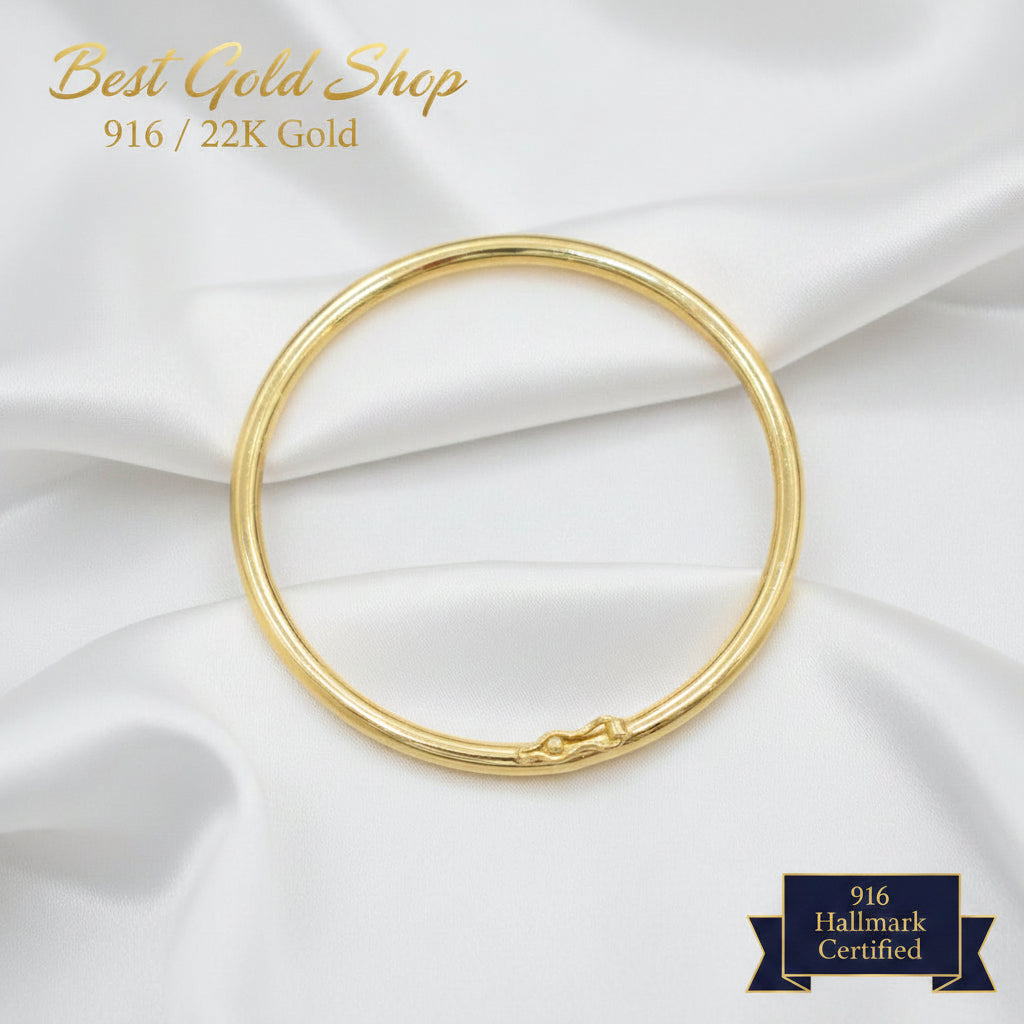 916 gold hollow shiny bangle on a dark background
