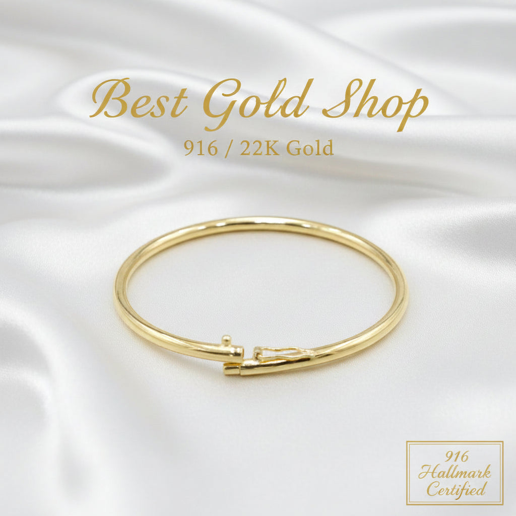 Profile view of a polished 916 gold hollow shiny bangle