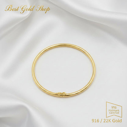 916 gold hollow shiny bangle on a white background