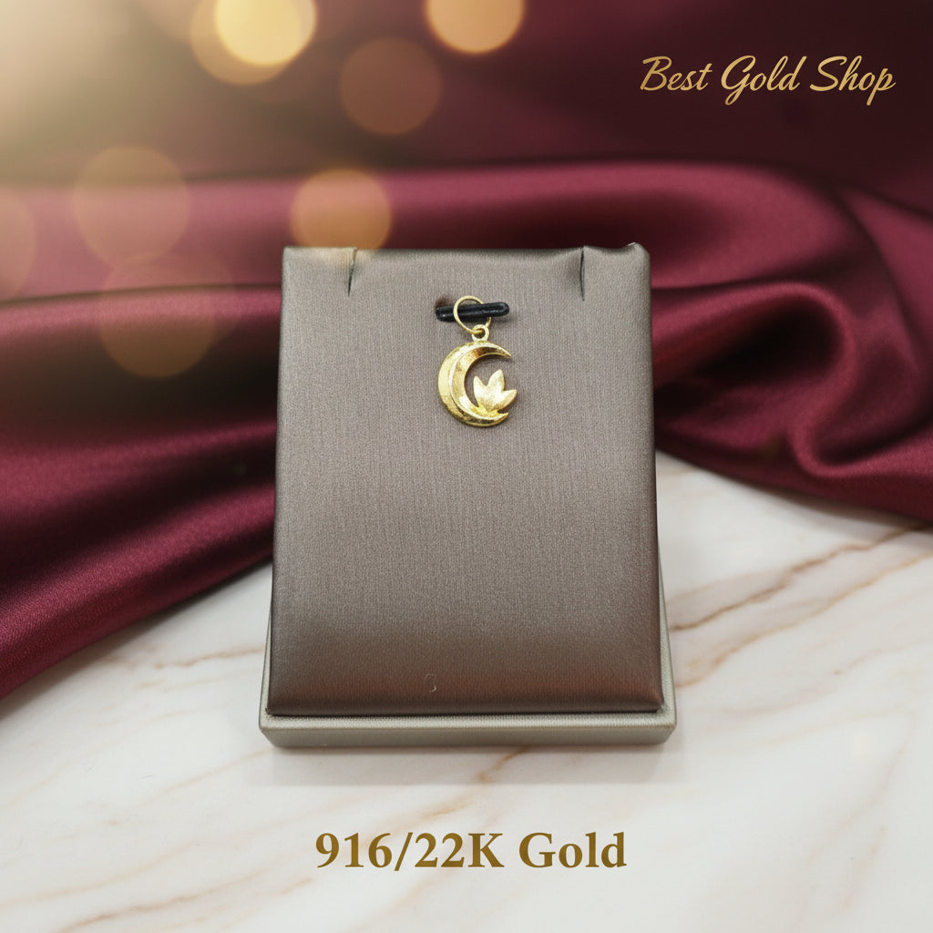 Detailed view of the floral motif on a 916 gold moon pendant