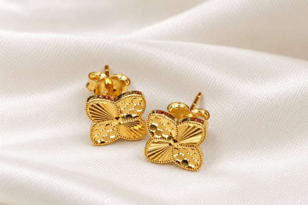916 gold petal earrings displayed together on light fabric