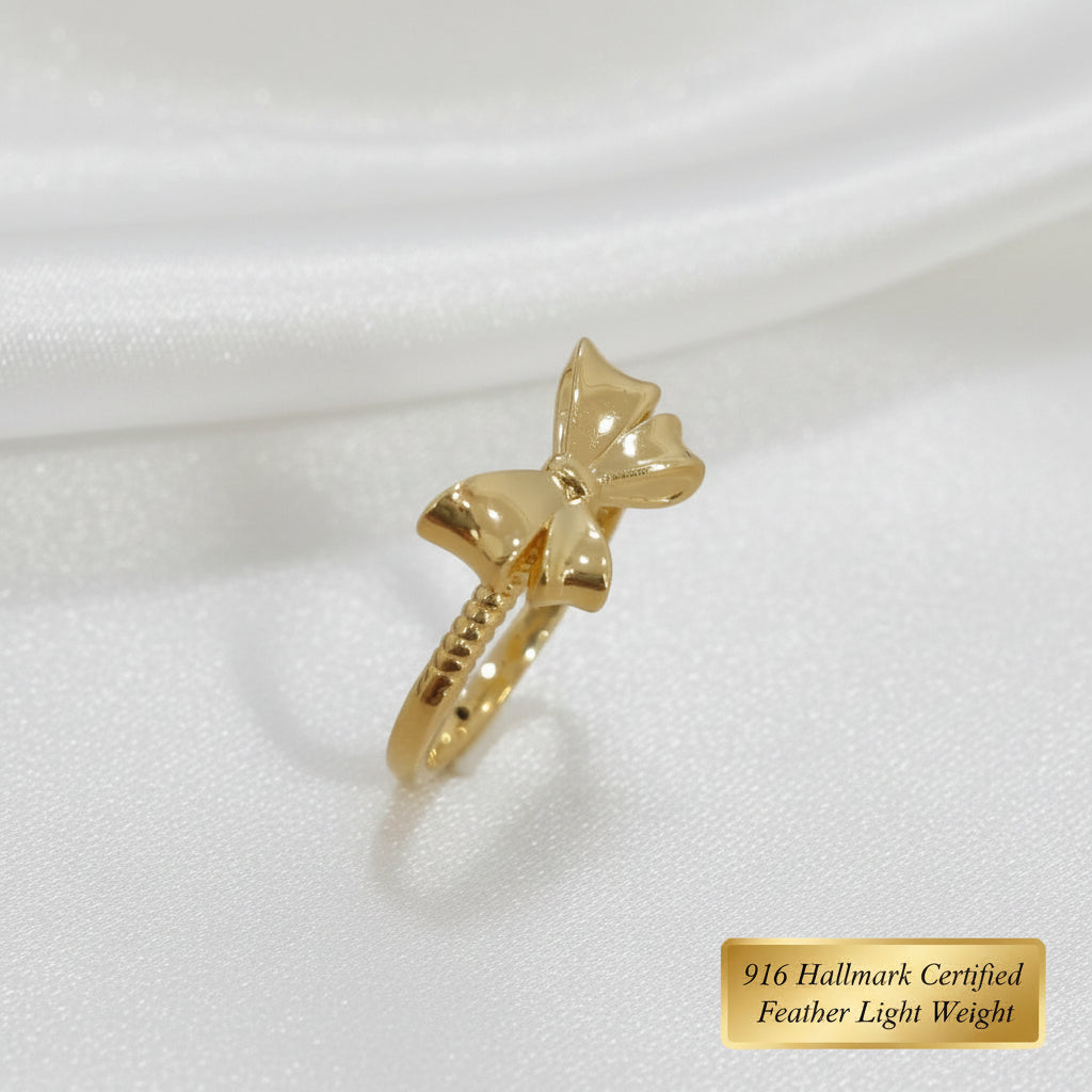 Side view of polished 916 gold ribbon bow ring