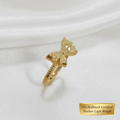 Side view of polished 916 gold ribbon bow ring
