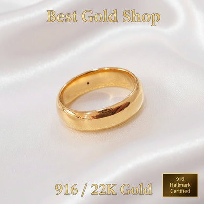 Close-up of polished 916 gold smooth band ring