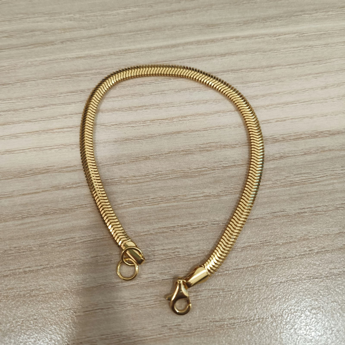 Close-up of 916 gold snake bracelet flexible chain links