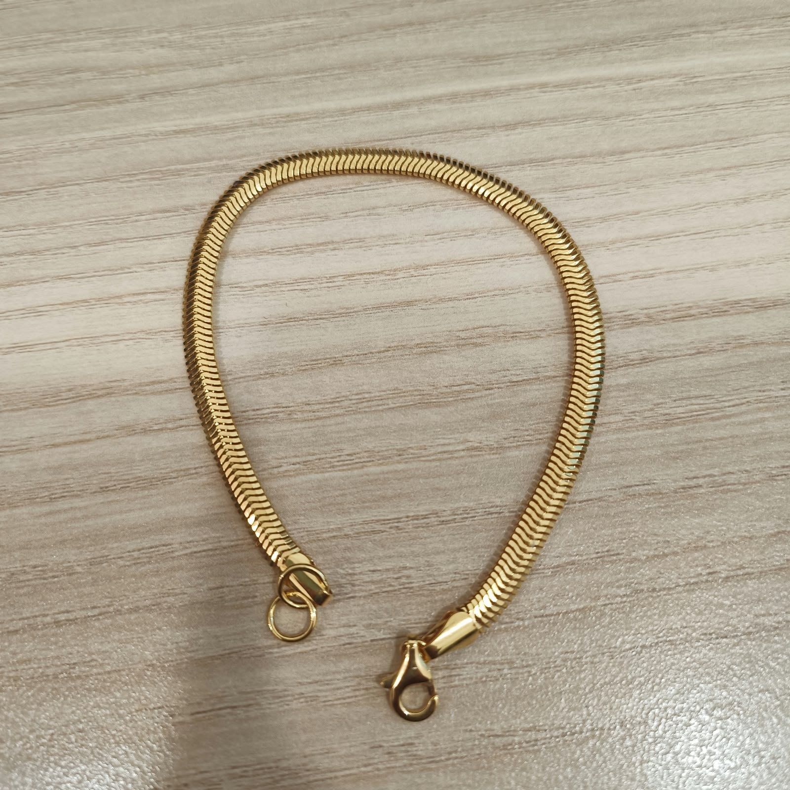 Close-up of 916 gold snake bracelet flexible chain links