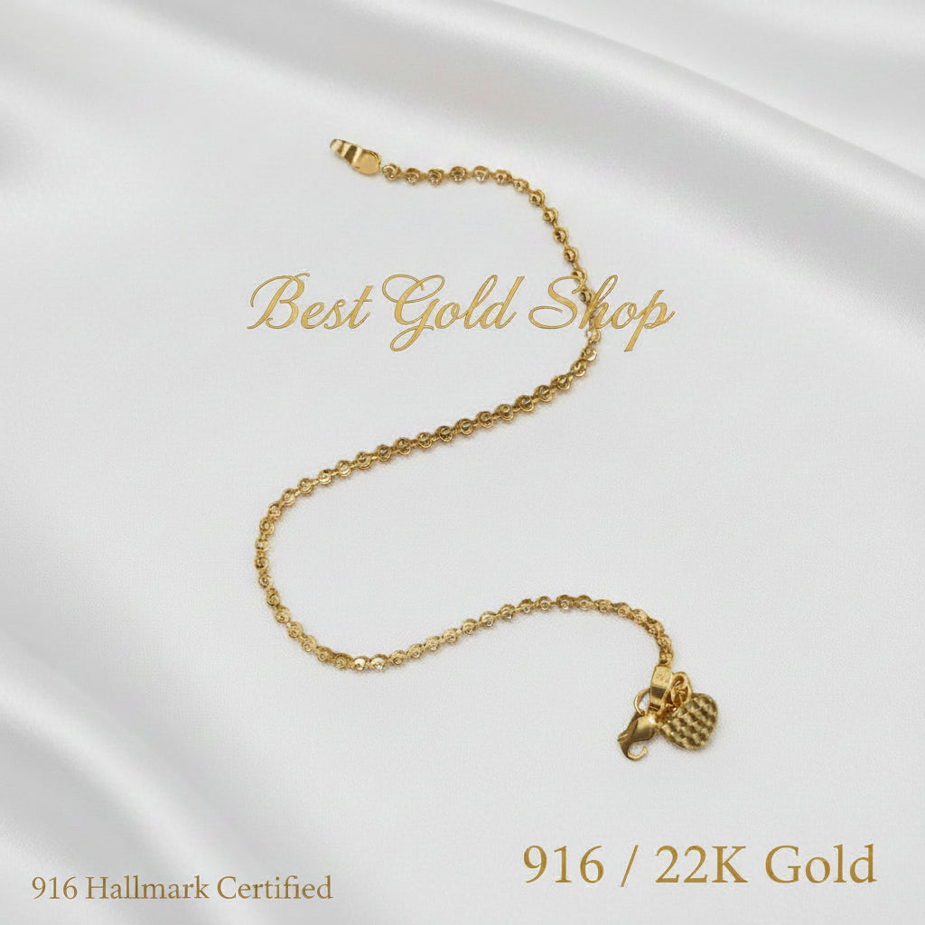 Close-up of clasp and heart charm on a 916 Gold bead bracelet.