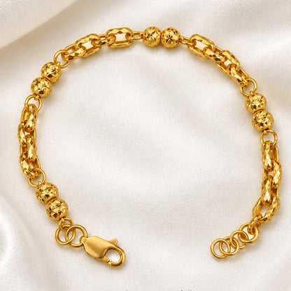 916 gold Wan Zi ball bracelet arranged in a circle with faceted beads and clasp on cream satin