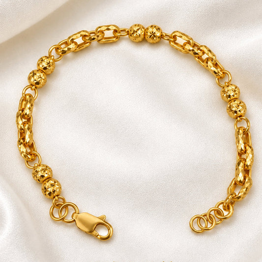 916 gold Wan Zi ball bracelet arranged in a circle with faceted beads and clasp on cream satin