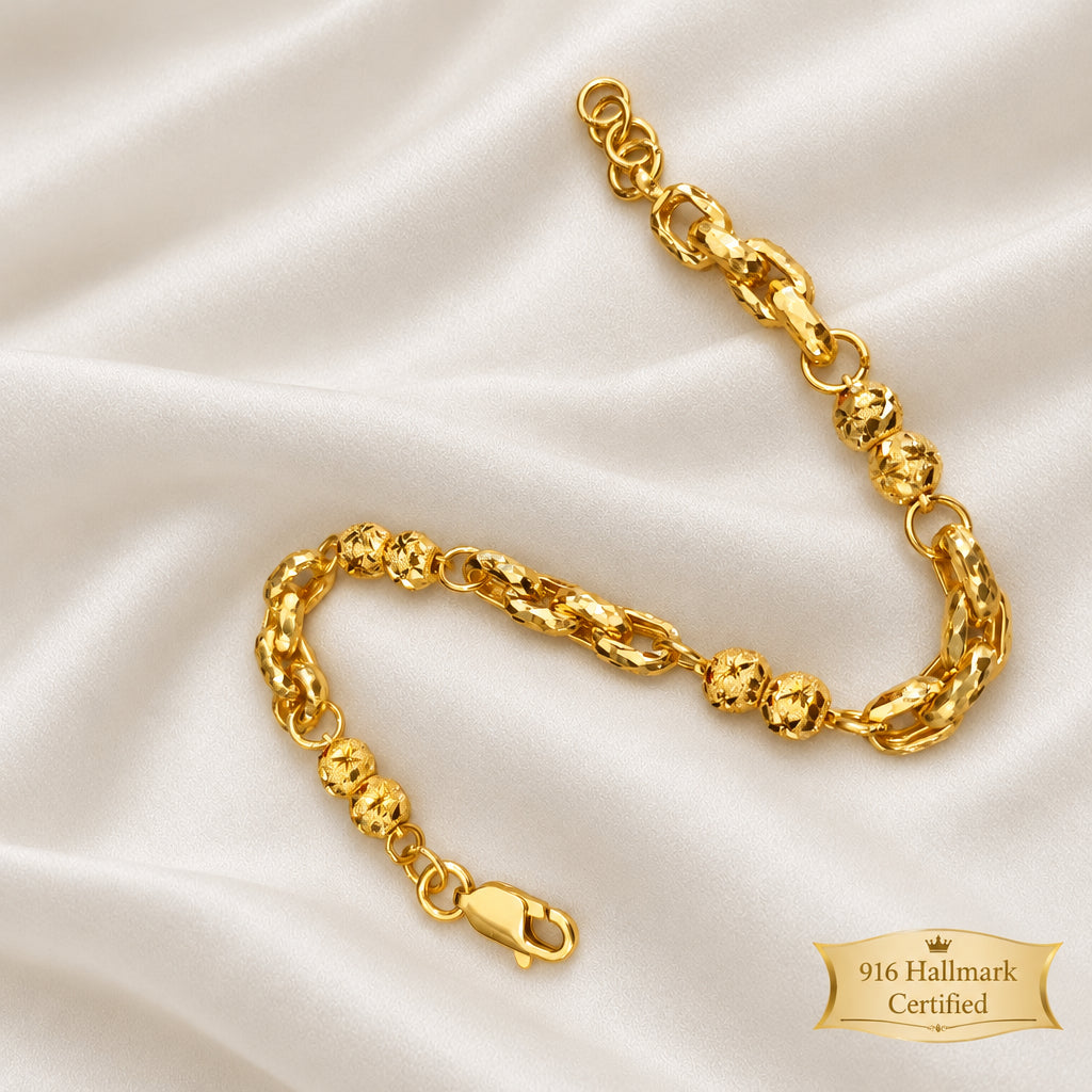 Wan Zi ball bracelet shown lengthwise on light fabric