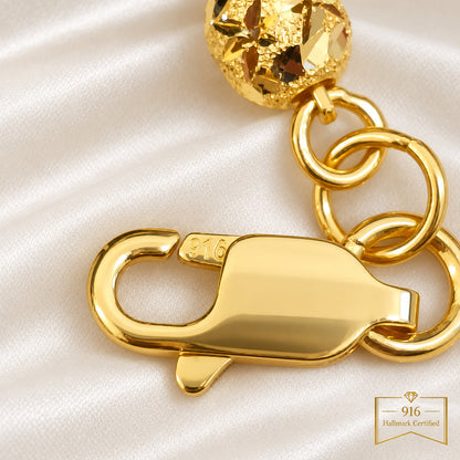 Close-up of the 916 stamp and lobster clasp on the Wan Zi ball bracelet