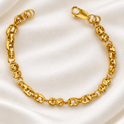 916 gold Wan Zi ball bracelet viewed from above with its clasp open on cream satin
